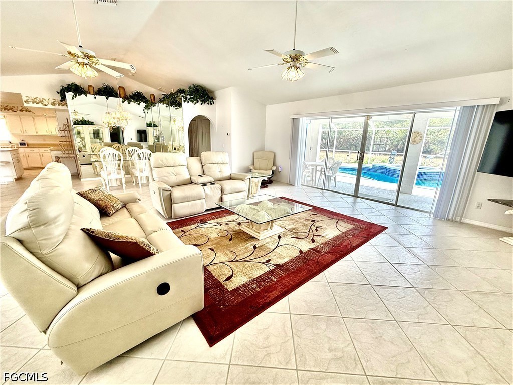 1400 Graham Circle Lehigh Acres, FL 33936 - Photo 16 of 47 a living room with furniture and a floor to ceiling window
