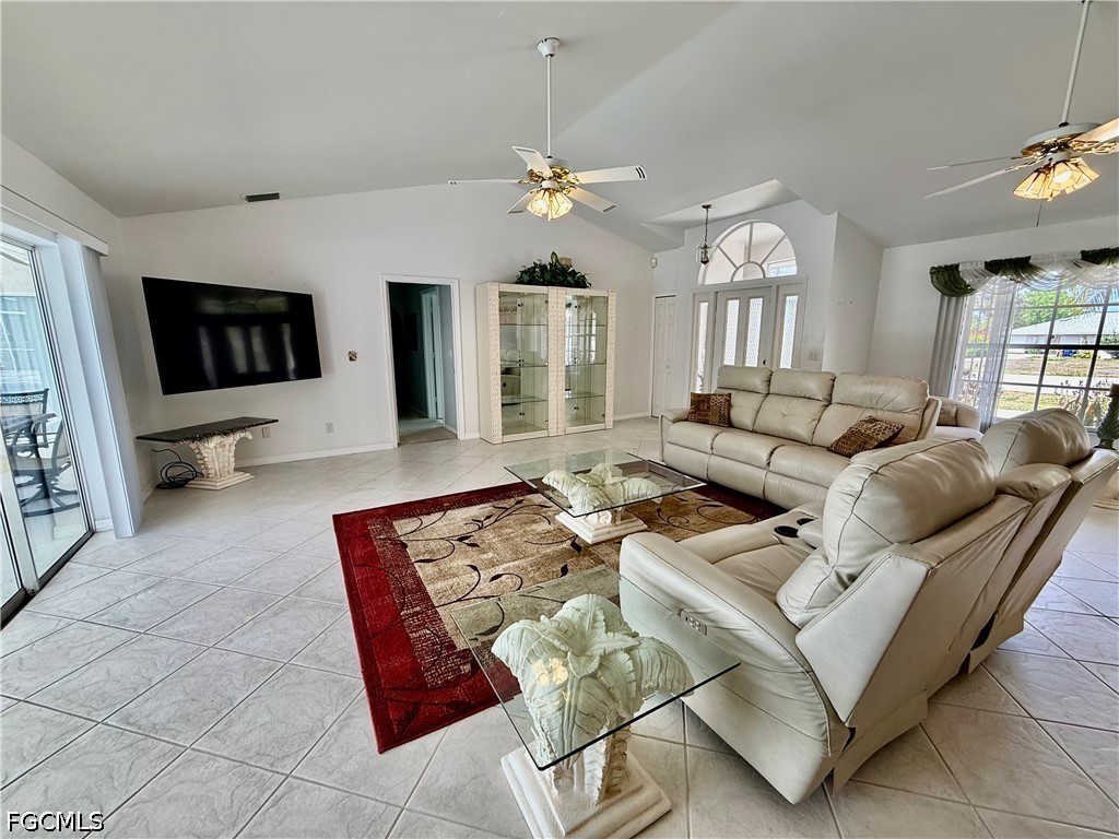 1400 Graham Circle Lehigh Acres, FL 33936 - Photo 18 of 47 a living room with furniture a chandelier and a flat screen tv