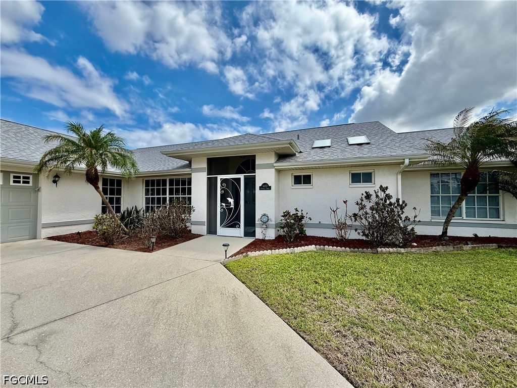 1400 Graham Circle Lehigh Acres, FL 33936 - Photo 2 of 47 a view of a house with a patio