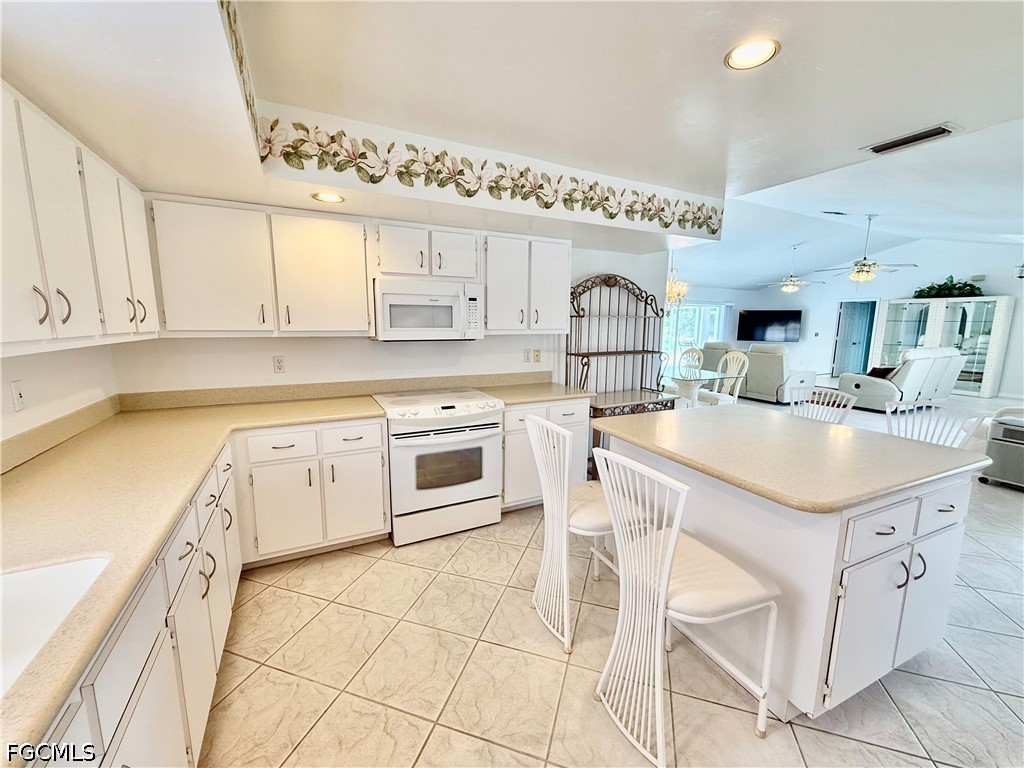 1400 Graham Circle Lehigh Acres, FL 33936 - Photo 21 of 47 a kitchen with a sink cabinets and window