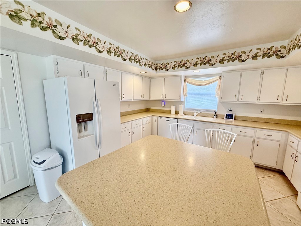 1400 Graham Circle Lehigh Acres, FL 33936 - Photo 23 of 47 a large white kitchen with a stove a sink and a refrigerator