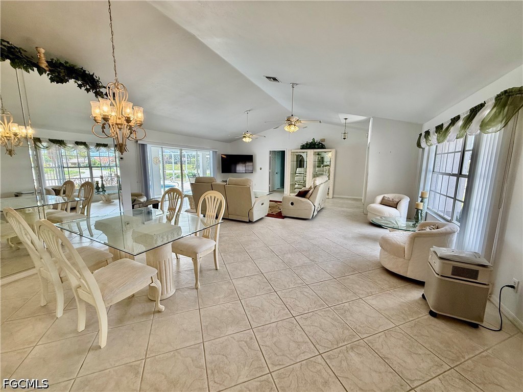 1400 Graham Circle Lehigh Acres, FL 33936 - Photo 25 of 47 a living room with patio furniture and a chandelier