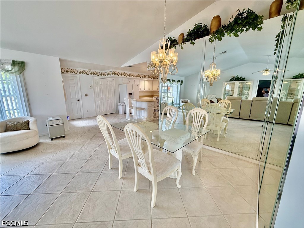 1400 Graham Circle Lehigh Acres, FL 33936 - Photo 27 of 47 a view of a dining room with furniture and a chandelier