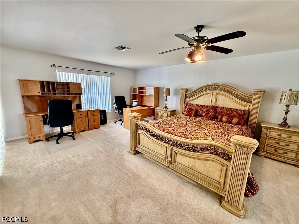 1400 Graham Circle Lehigh Acres, FL 33936 - Photo 29 of 47 a living room with furniture and a ceiling fan