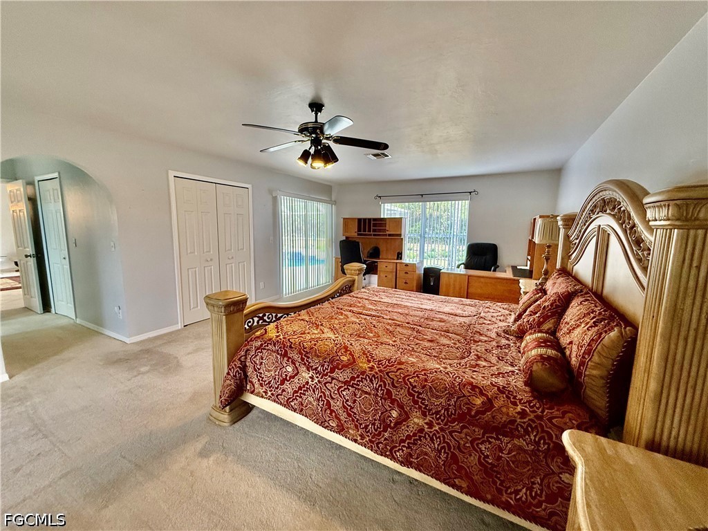 1400 Graham Circle Lehigh Acres, FL 33936 - Photo 30 of 47 a bed room with a bed and a chandelier