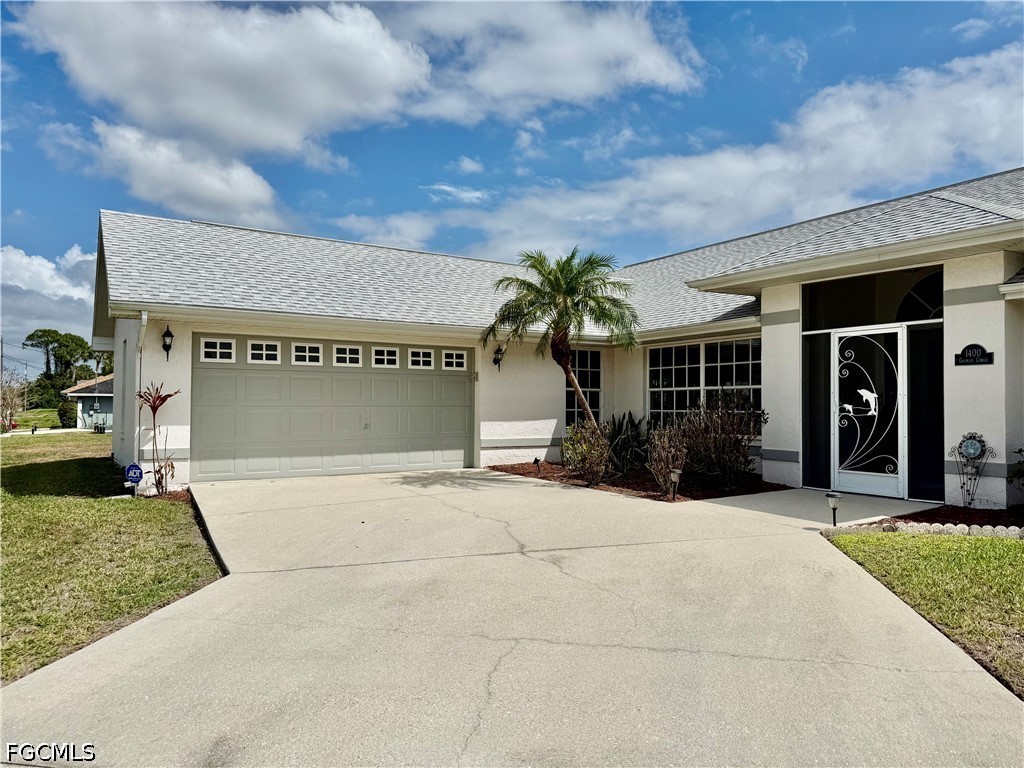 1400 Graham Circle Lehigh Acres, FL 33936 - Photo 3 of 47 a view of a house with a yard and potted plants