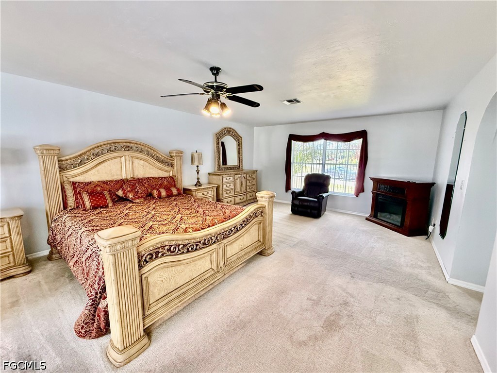 1400 Graham Circle Lehigh Acres, FL 33936 - Photo 32 of 47 a spacious bedroom with a bed and dresser