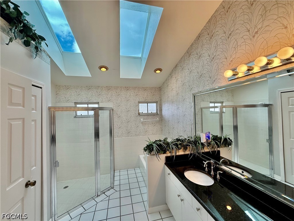 1400 Graham Circle Lehigh Acres, FL 33936 - Photo 35 of 47 a bathroom with a sink vanity granite shower and a mirror