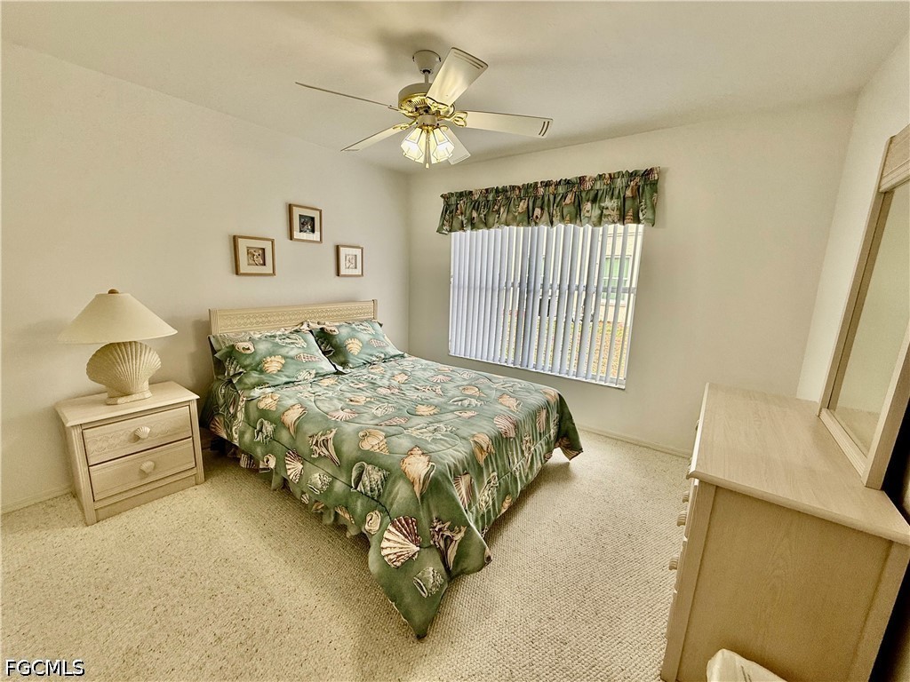 1400 Graham Circle Lehigh Acres, FL 33936 - Photo 37 of 47 a bedroom with a bed and a chandelier