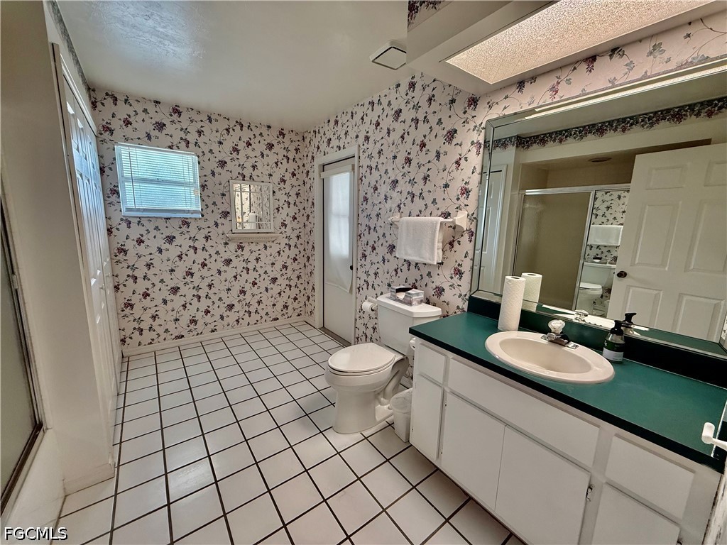 1400 Graham Circle Lehigh Acres, FL 33936 - Photo 38 of 47 a bathroom with a granite countertop sink toilet and shower
