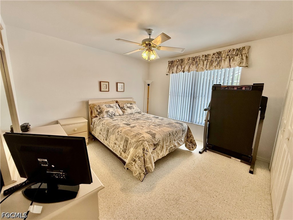 1400 Graham Circle Lehigh Acres, FL 33936 - Photo 39 of 47 a bedroom with a bed dresser and a window