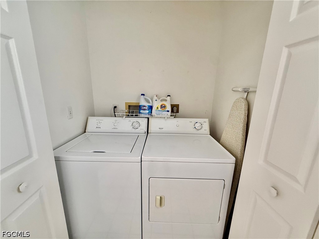 1400 Graham Circle Lehigh Acres, FL 33936 - Photo 40 of 47 a utility room with dryer and washer