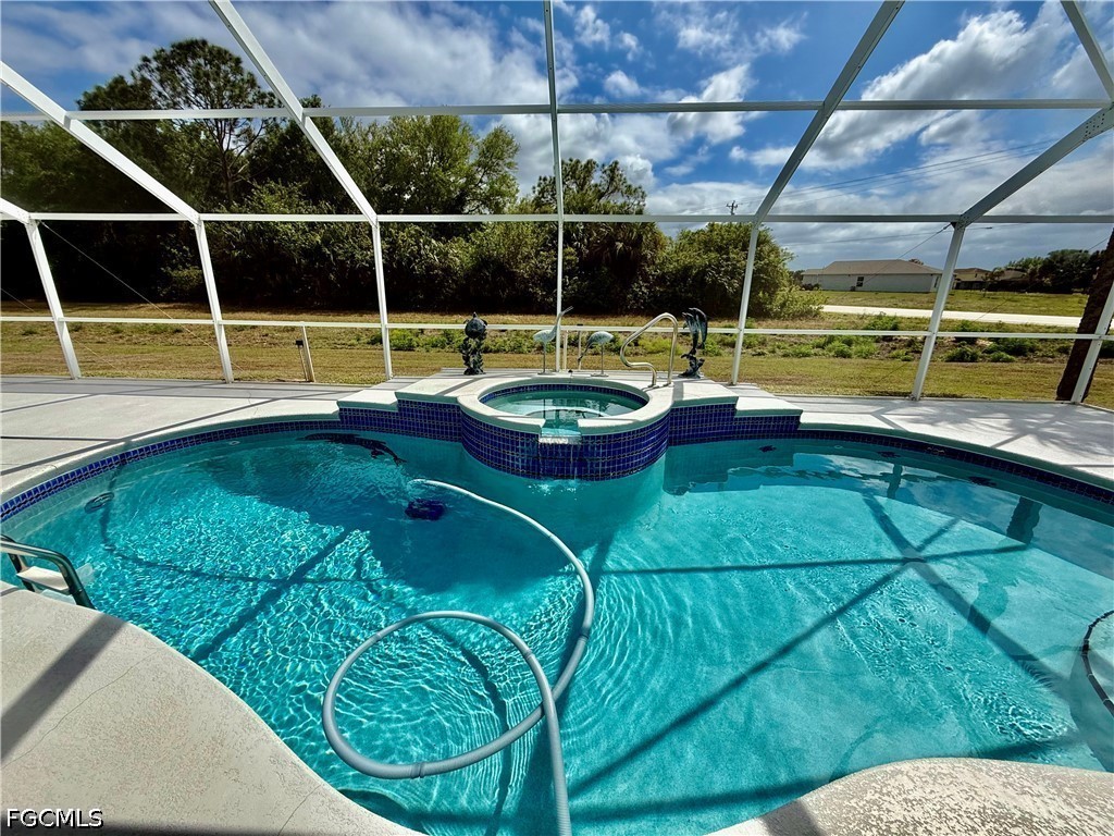 1400 Graham Circle Lehigh Acres, FL 33936 - Photo 4 of 47 a view of a swimming pool with a yard and potted plants