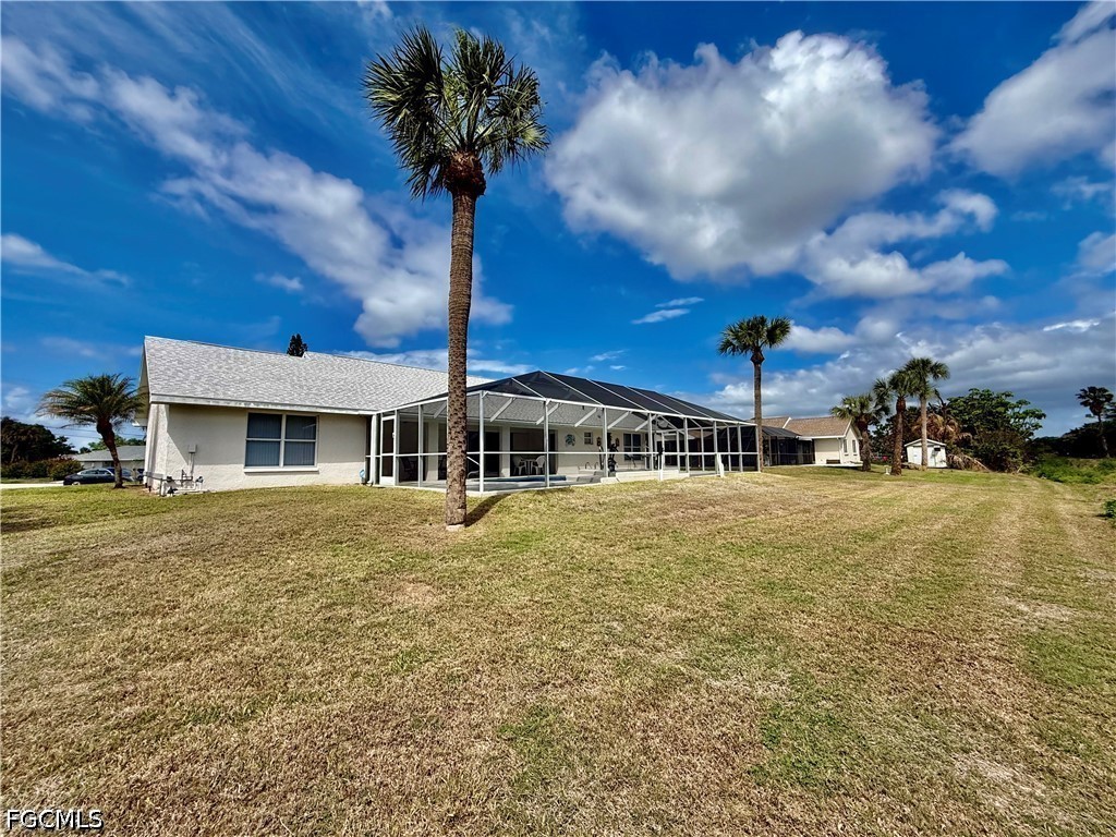 1400 Graham Circle Lehigh Acres, FL 33936 - Photo 41 of 47 a front view of a house with a garden