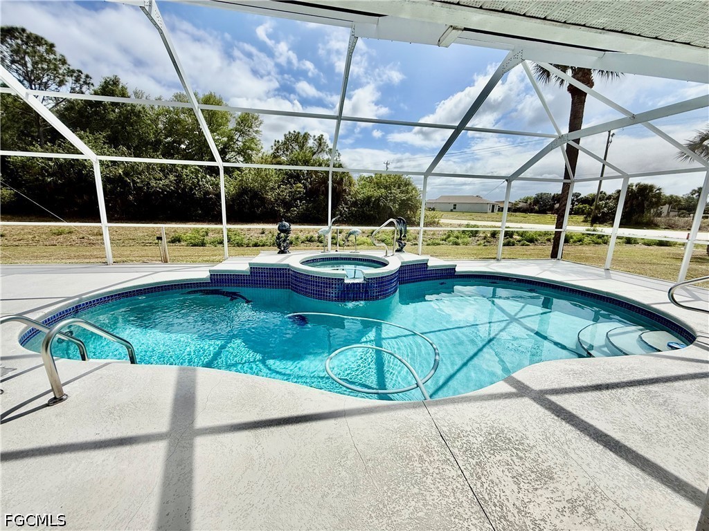 1400 Graham Circle Lehigh Acres, FL 33936 - Photo 5 of 47 a view of a swimming pool with a yard and sitting area