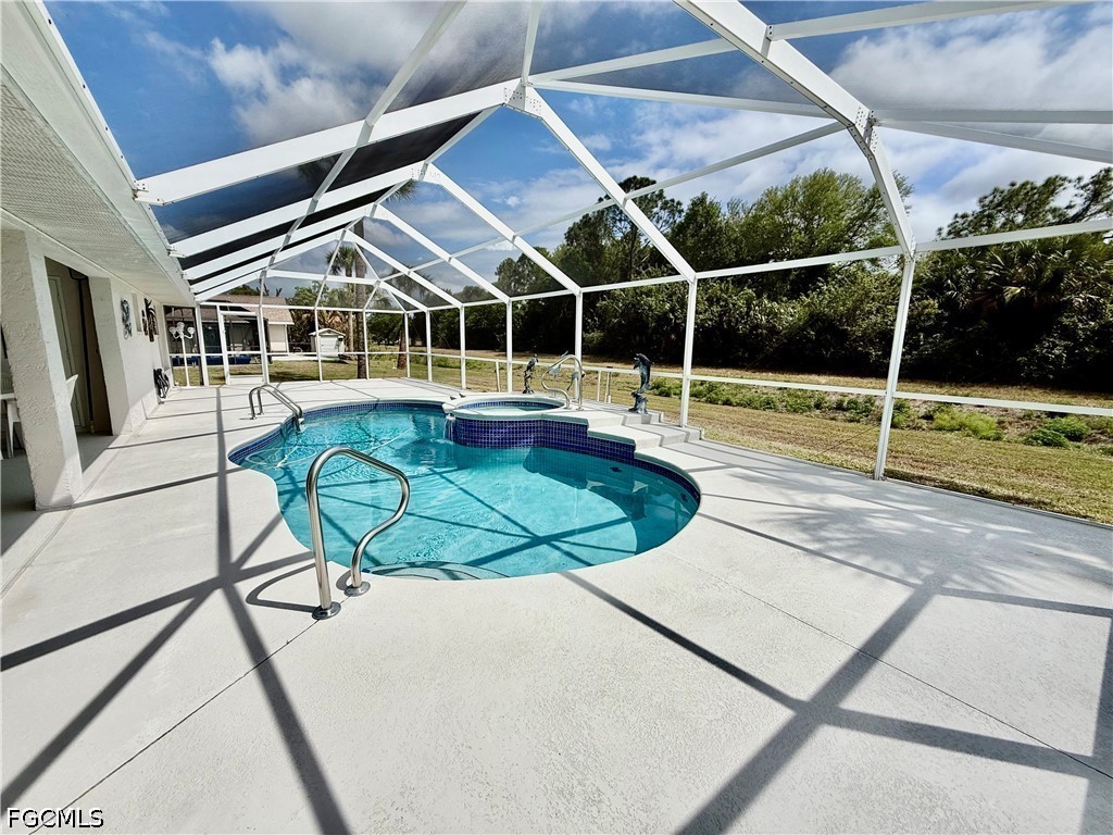 1400 Graham Circle Lehigh Acres, FL 33936 - Photo 8 of 47 a view of a swimming pool with a lounge chairs