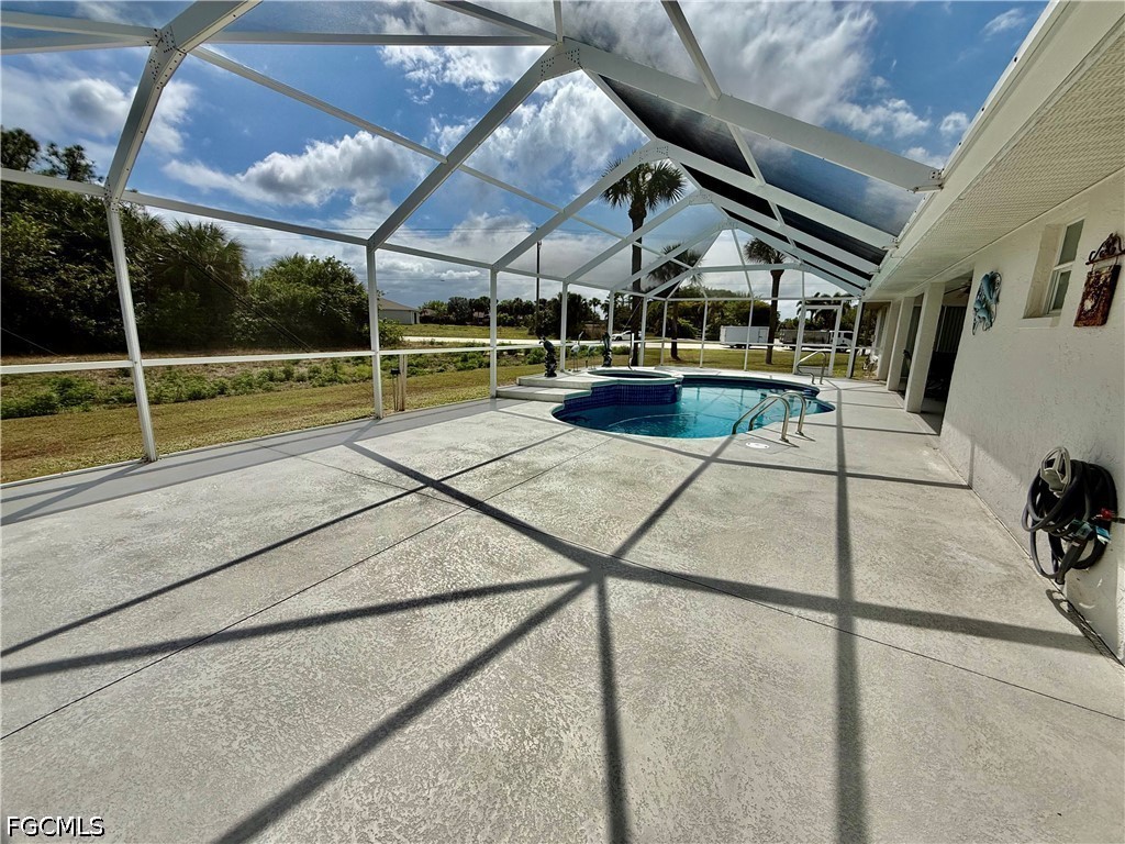 1400 Graham Circle Lehigh Acres, FL 33936 - Photo 9 of 47 a view of a swimming pool with a patio