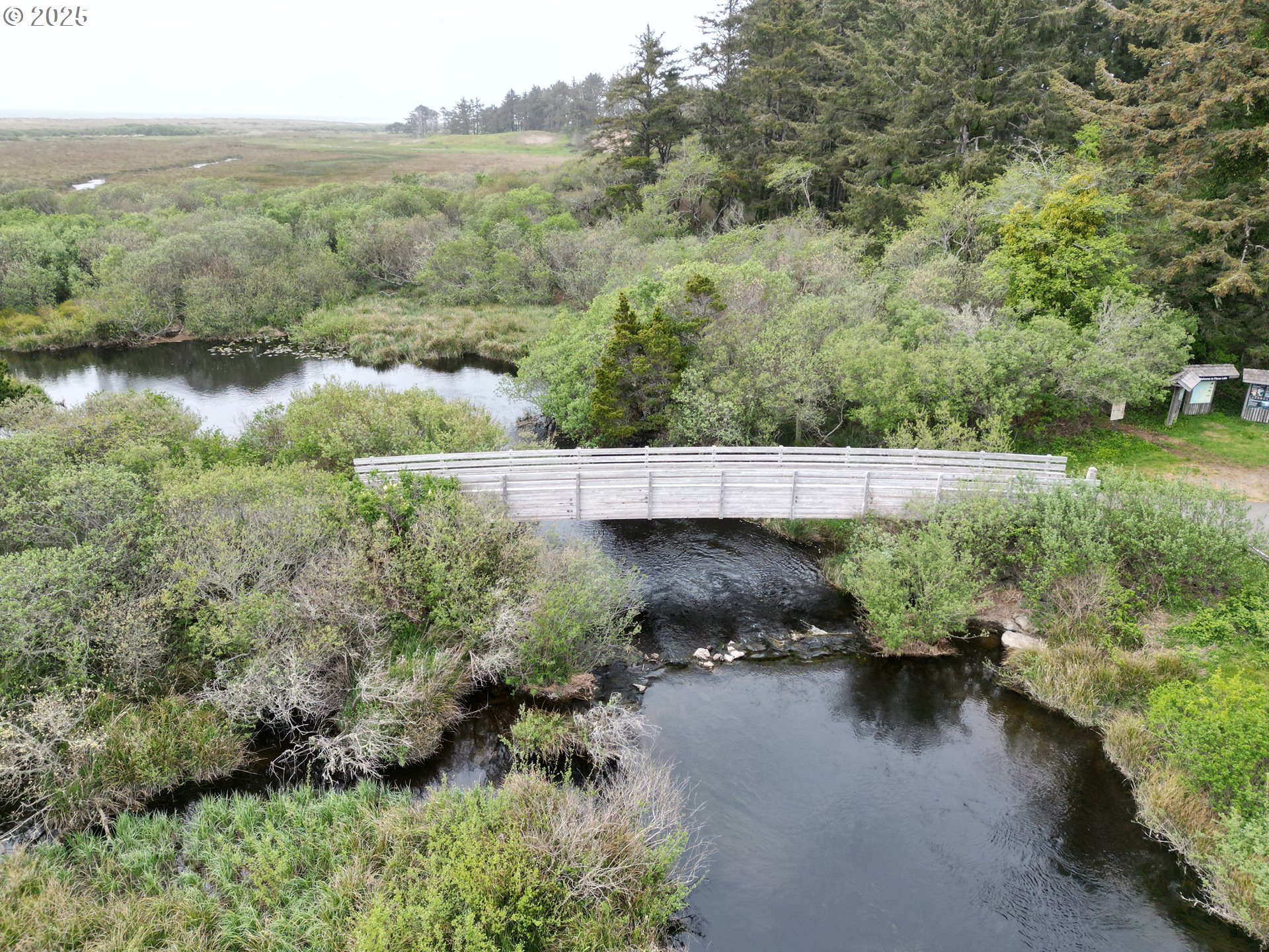 Lakeshore Drive Langlois, OR 97450 - Photo 6 of 14 an aerial view of a house with a yard and lake view