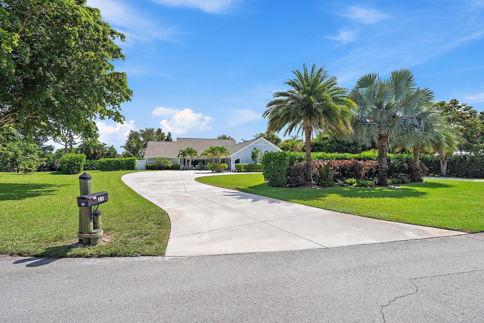 11 Loggerhead Lane Tequesta, FL 33469 - Photo 1 of 46 a view of a garden with palm trees