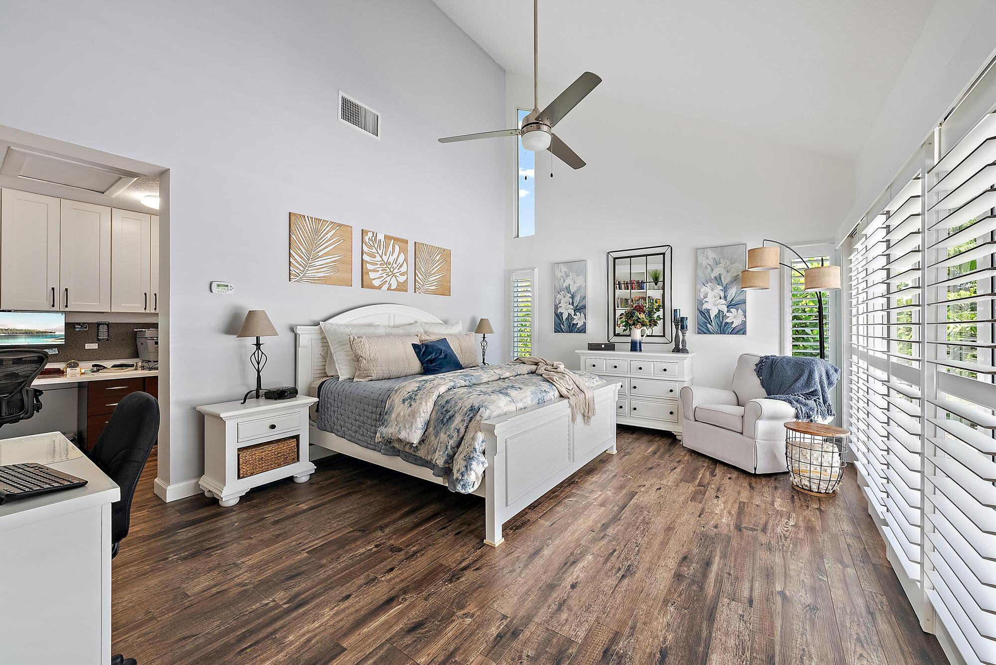 11 Loggerhead Lane Tequesta, FL 33469 - Photo 18 of 46 a bedroom with a bed and wooden floor