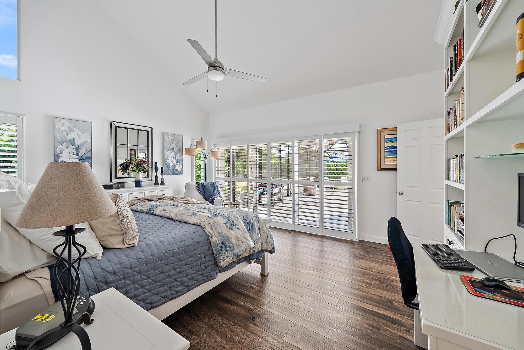 11 Loggerhead Lane Tequesta, FL 33469 - Photo 19 of 46 a bedroom with a bed and wooden floor