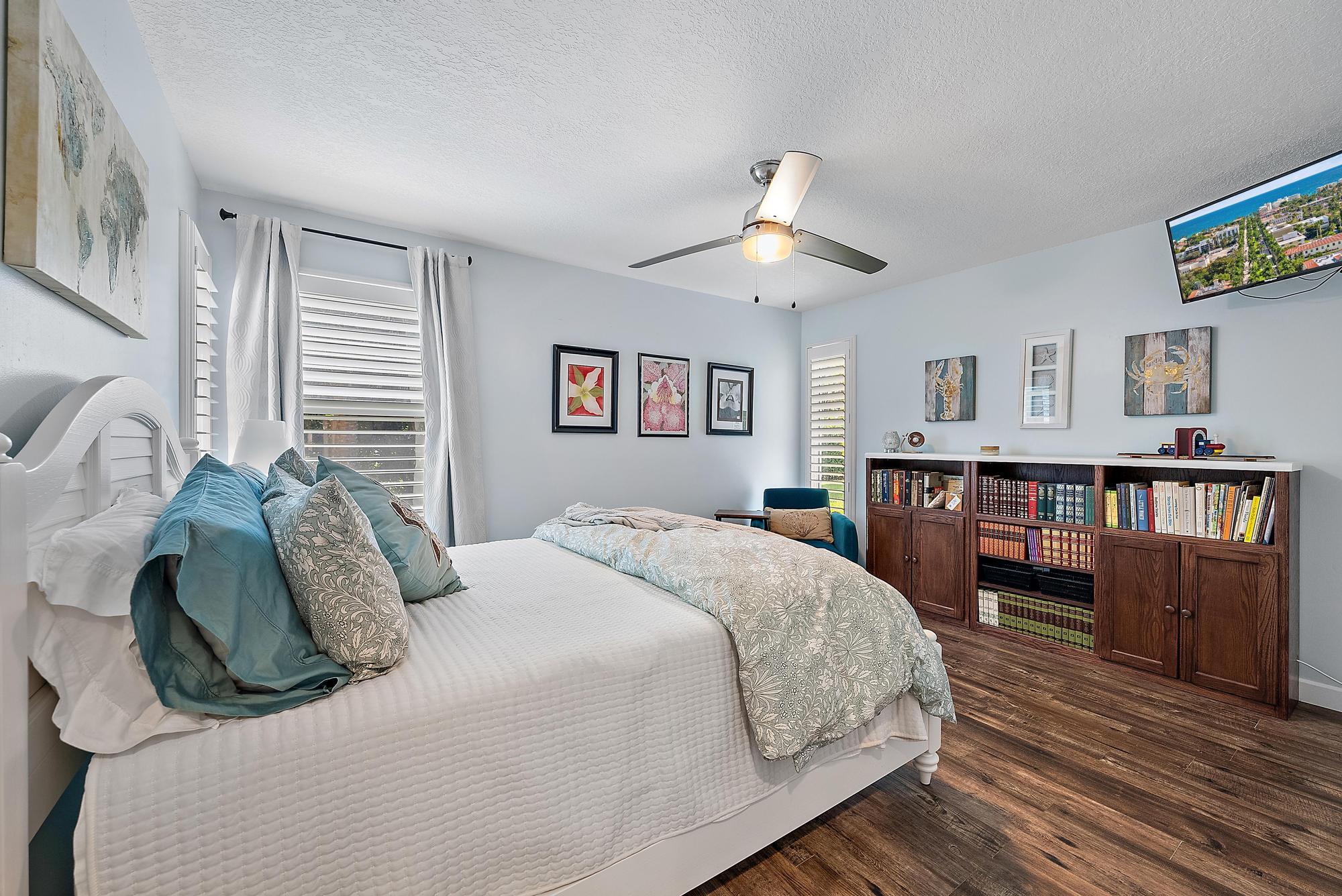 11 Loggerhead Lane Tequesta, FL 33469 - Photo 2 of 46 a bedroom with a large bed and a chandelier