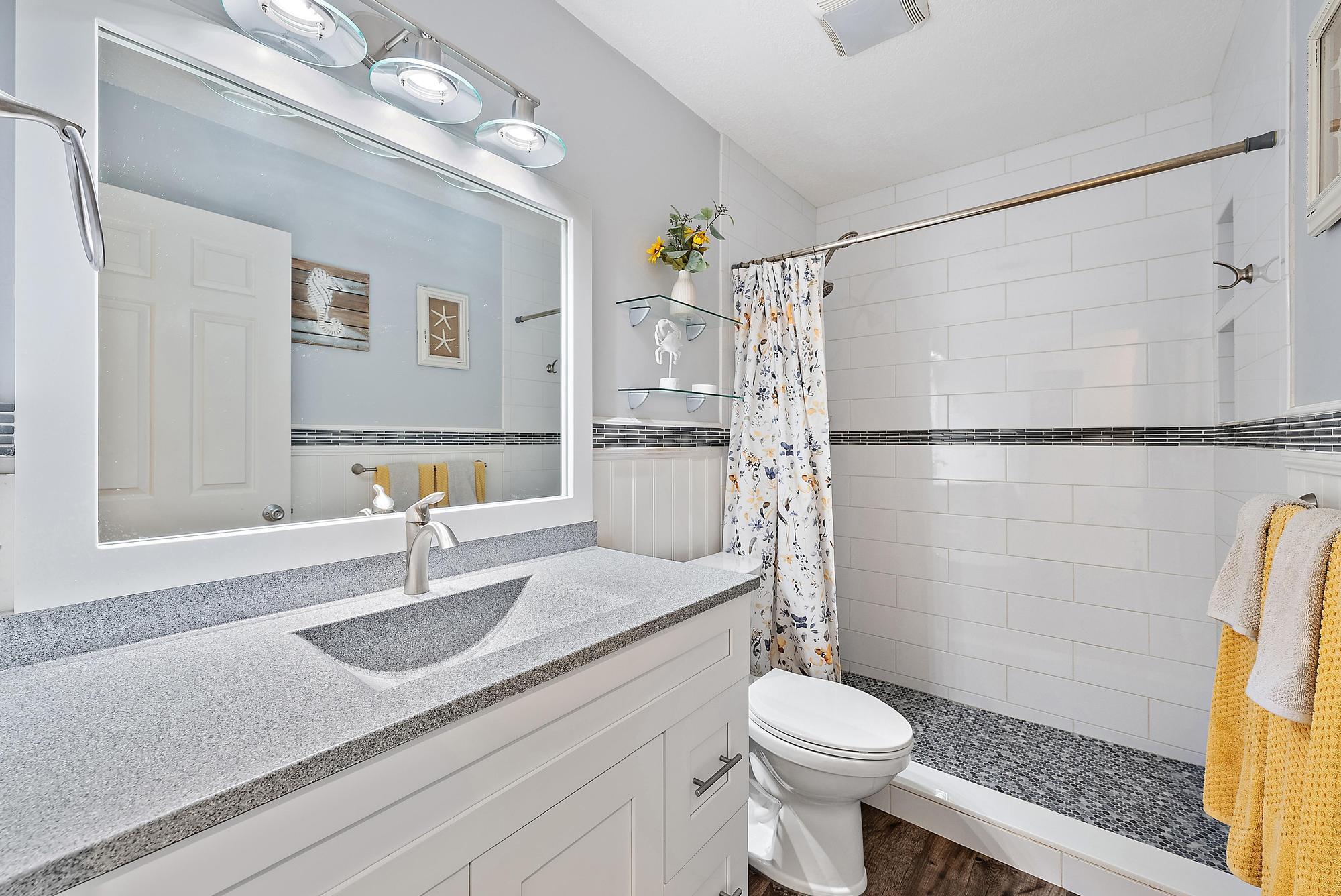 11 Loggerhead Lane Tequesta, FL 33469 - Photo 27 of 46 a bathroom with a sink a toilet and shower