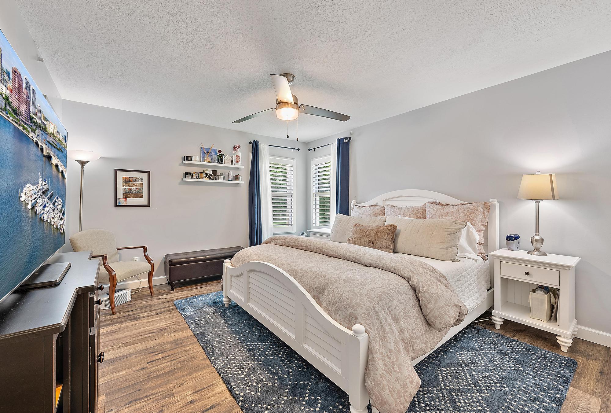 11 Loggerhead Lane Tequesta, FL 33469 - Photo 28 of 46 a bedroom with bed and a chandelier