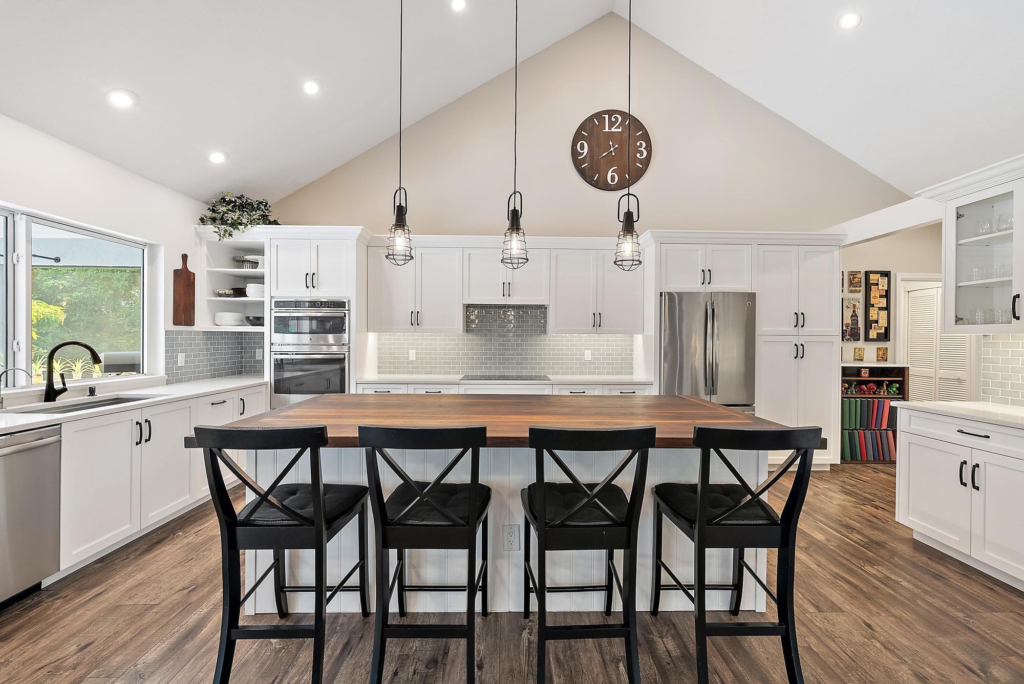 11 Loggerhead Lane Tequesta, FL 33469 - Photo 10 of 46 a kitchen with stainless steel appliances kitchen island a dining table and chairs