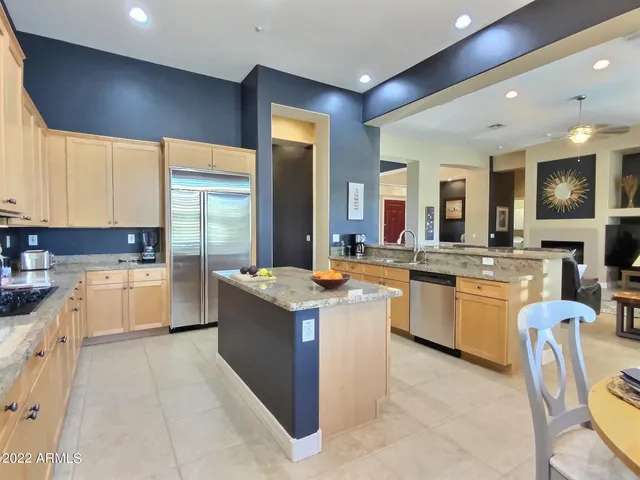 a kitchen with a refrigerator sink and cabinets