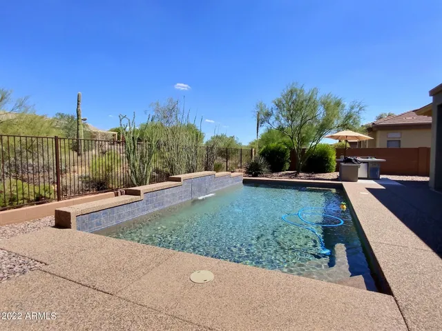 a view of a yard with chairs