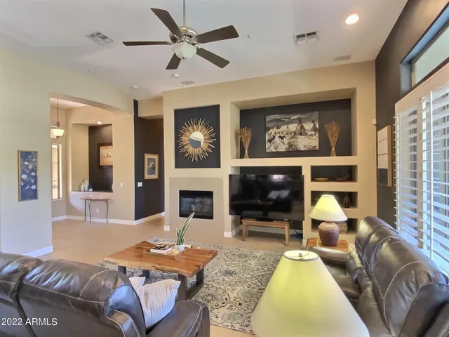 a living room with furniture and a floor to ceiling window
