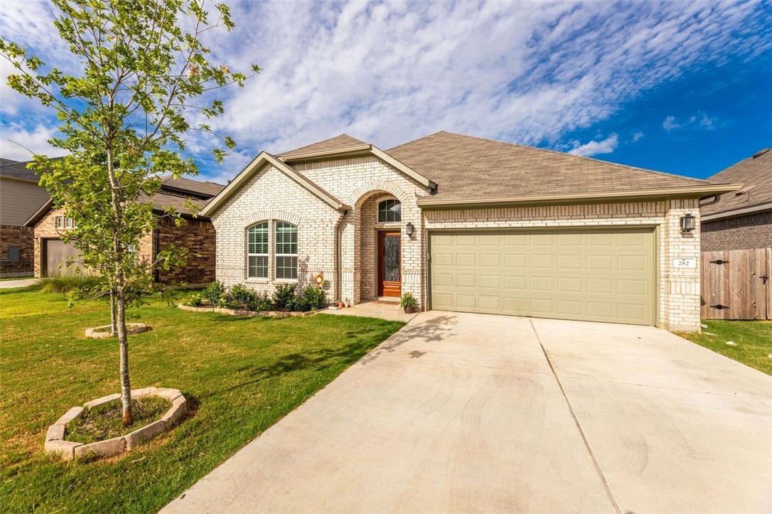 282 Cherrystone Loop Buda, TX 78610 - Photo 1 of 1 a front view of a house with garden