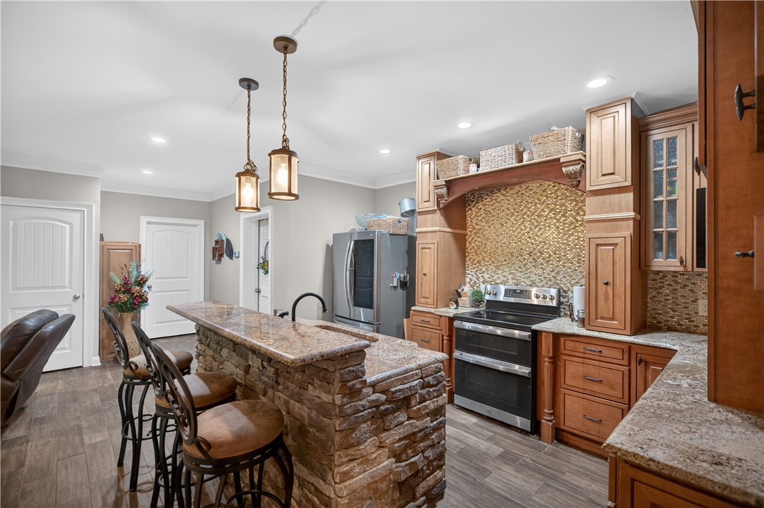 206 James Hare Road Anderson, SC 29626 - Photo 15 of 37 A rustic-inspired kitchen island provides a perfect breakfast bar with stone accents and granite counters.