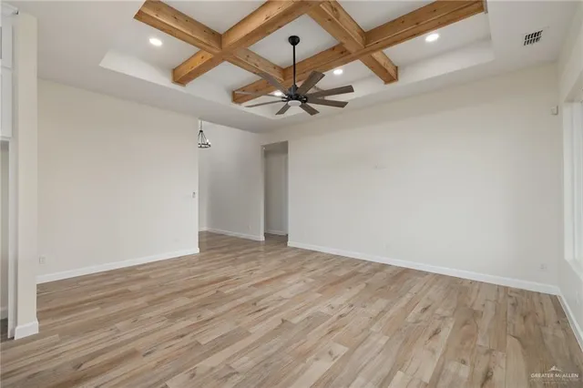 a kitchen with white cabinets and sink
