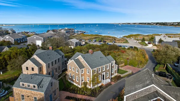 an aerial view of residential building with outdoor space and ocean