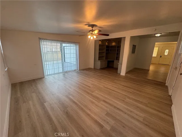 wooden floor in an empty room with a window