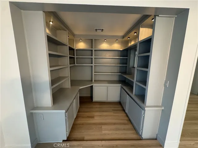 a view of walk in closet with empty racks
