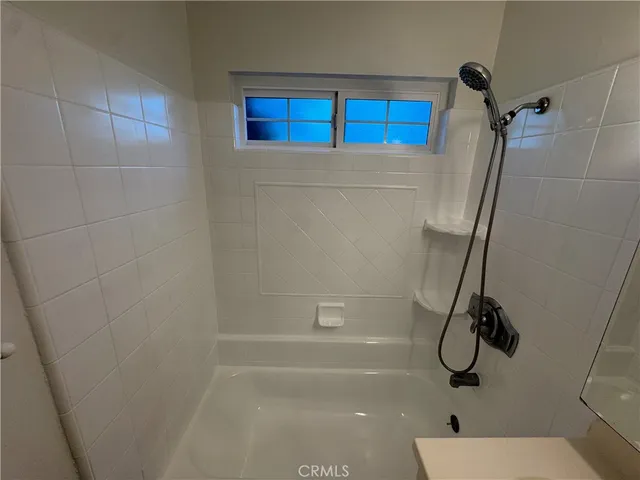 a bathroom with a shower and a toilet