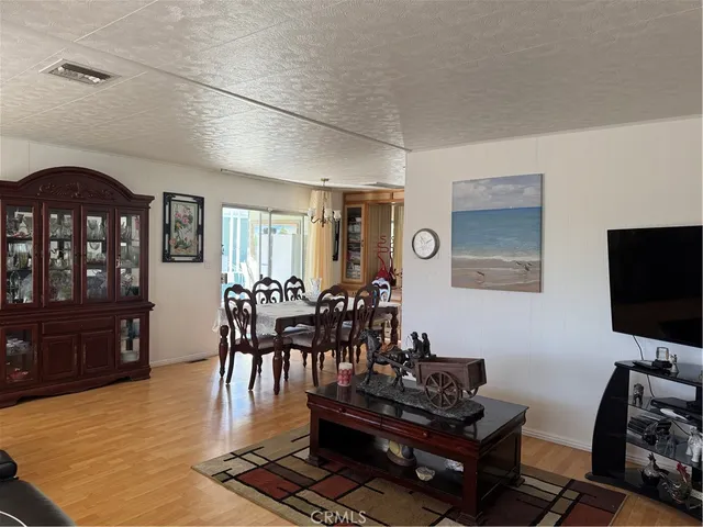 a view of a a dining room with furniture window and wooden floor