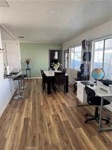 a kitchen with stainless steel appliances granite countertop a sink a stove a refrigerator and cabinets