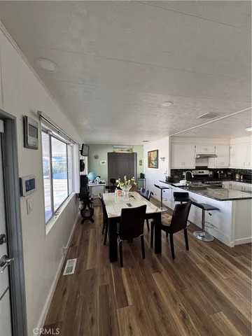 a kitchen with kitchen island granite countertop a sink stove and cabinets