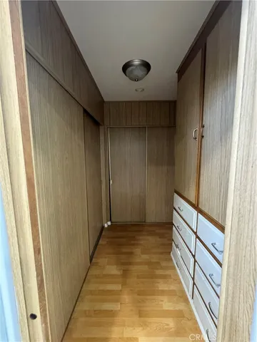 a bedroom with a bed window television and a mirror