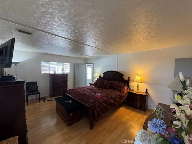 a bedroom with a bed and a mirror