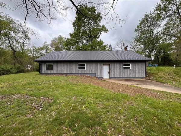 a house with huge green field in front of it
