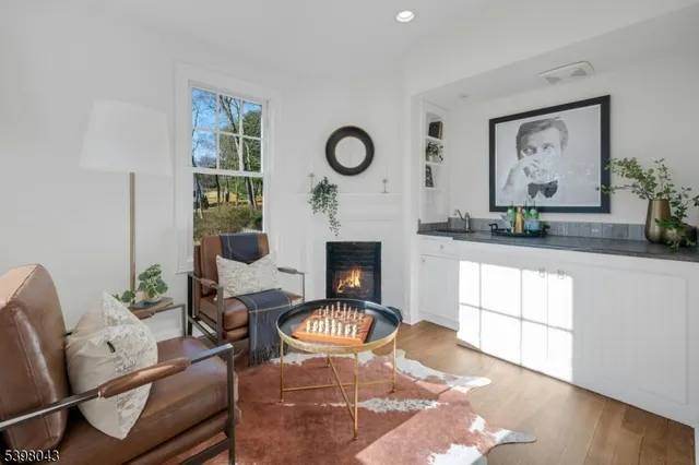 a living room with furniture a rug and a fireplace
