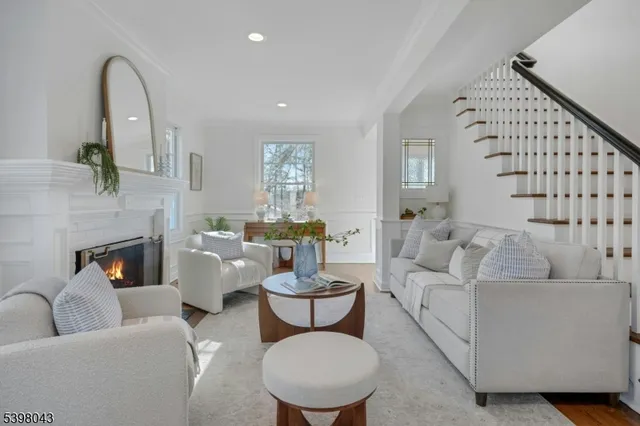 a living room with furniture a fireplace and a potted plant