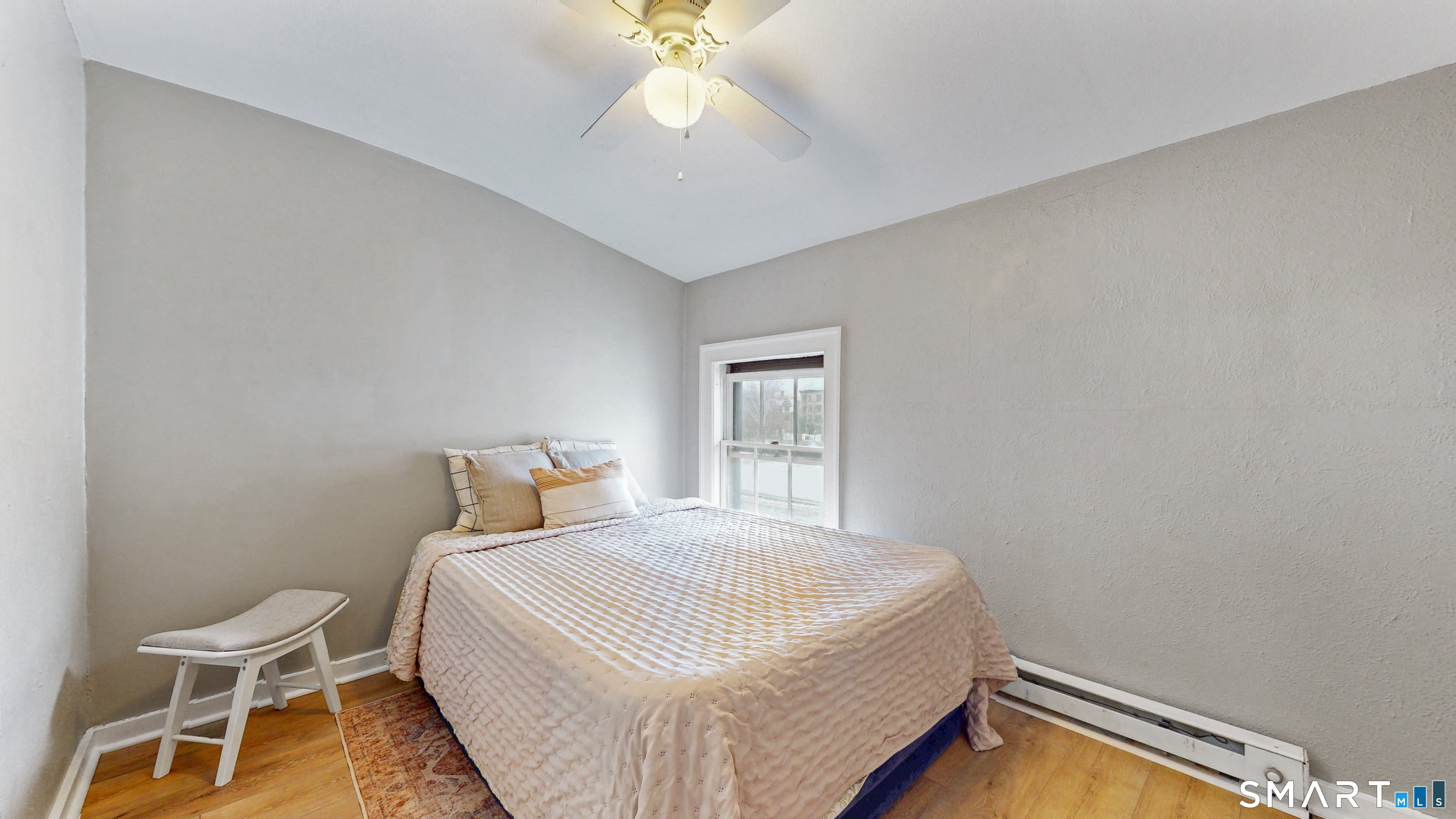 24 Madison Street Hartford, CT 06106 - Photo 15 of 18 a bedroom with a bed and a chandelier