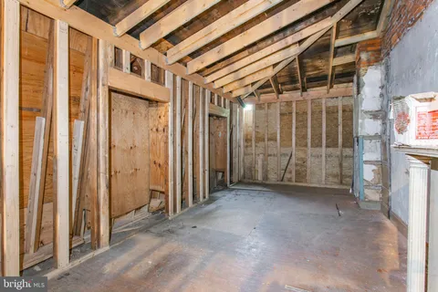 a view of a room with wooden floor and windows