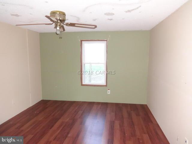 36778-3 3 Bridges Road Willards, MD 21874 - Photo 14 of 18 a view of a room with wooden floor fan and window